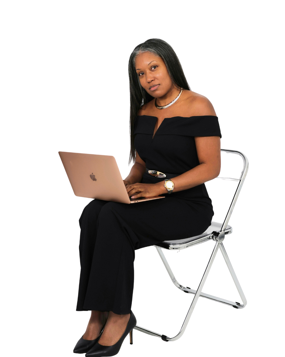 Tunisha Renee seated with a laptop looking at camera